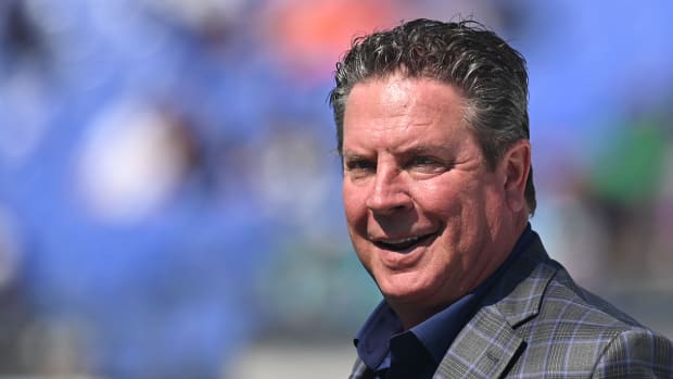 Dan Marino stands on the field before the game between the Baltimore Ravens and the Miami Dolphins at M&T Bank Stadium.